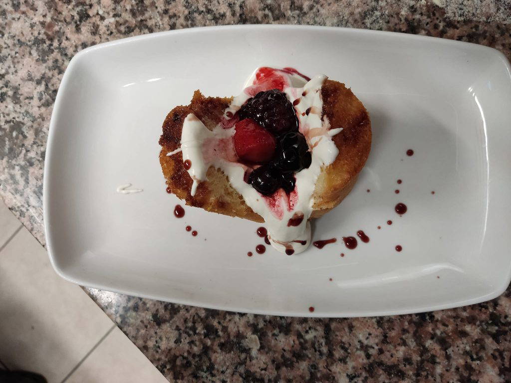 Rum Baba with cream and mix berries. Very boozy